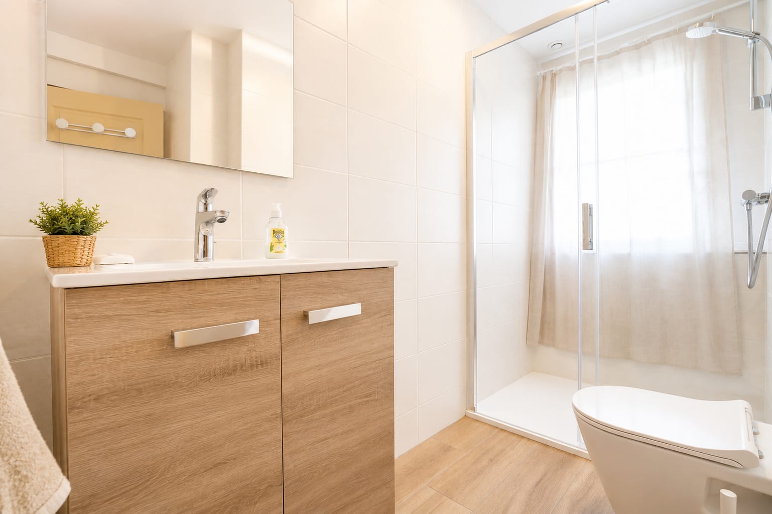 Salle de bains rénovée avec meuble bois, douche et WC